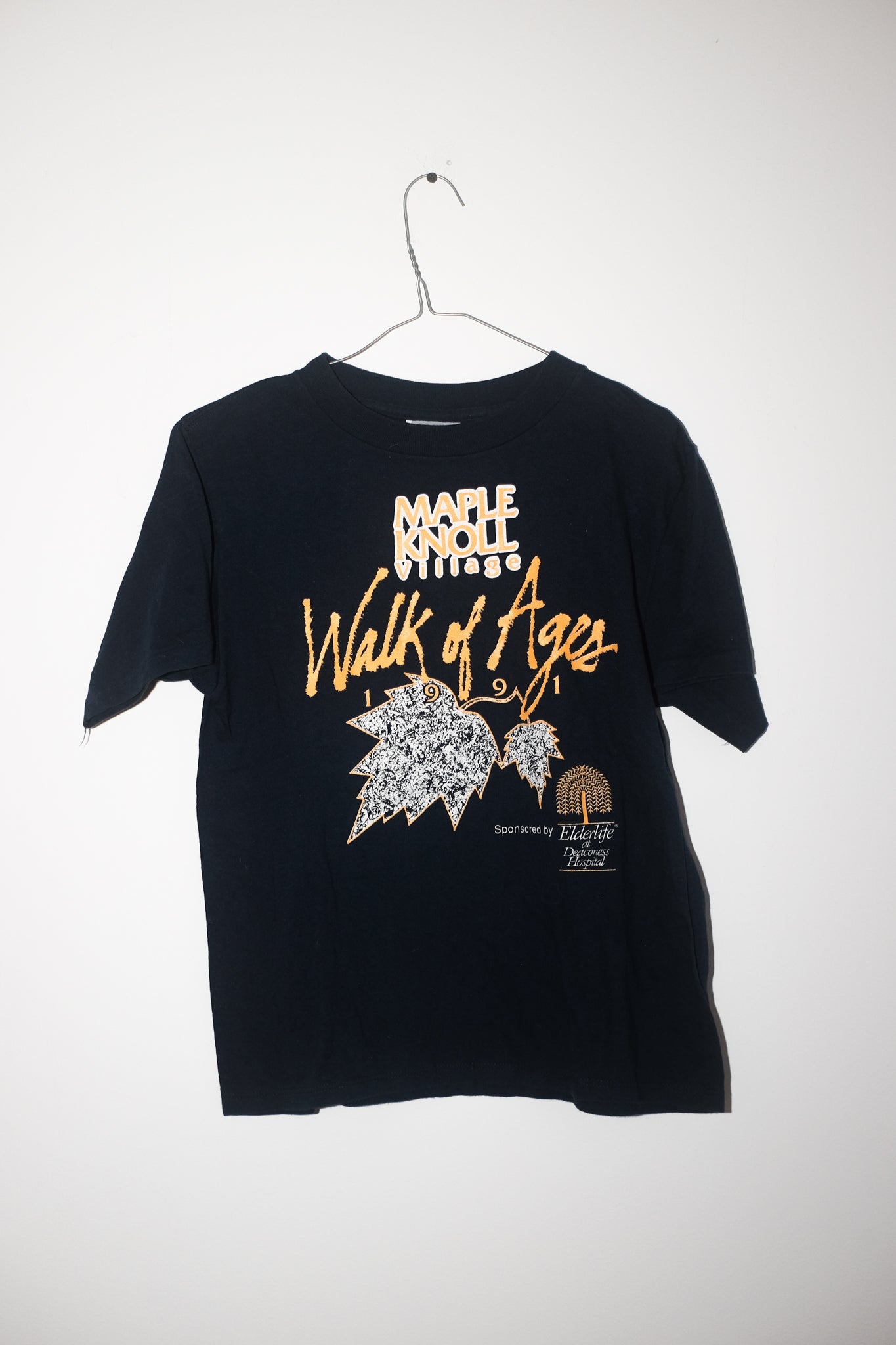 Black t-shirt with graphic design and text on a white background